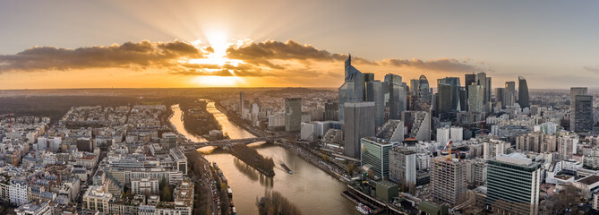 Aerial pano drone shot of La Defense skyscraper complex by la Seine with Pont Neuilly during sunset...