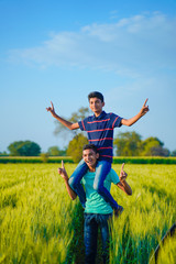 two indian rural brother playing at field