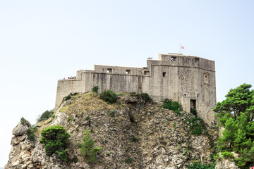 Fototapeta premium Dubrovnik old town city view, old castle view, Ancient fortress view and houses, a castle on the sea bay, hand made walls build with old bricks and stones, Croatia