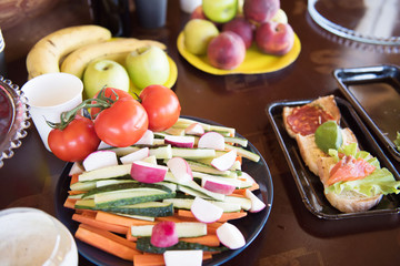 Natural summer healthy products. Table full of snacks, fruits and vegetables prepared for guests.