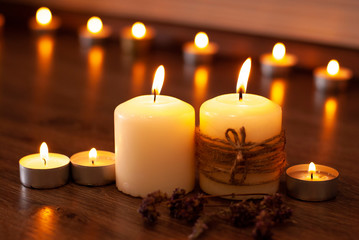 Aromatherapy flame closeup picture. Beautyful burning light yellow creme vanilla candles with wooden background
