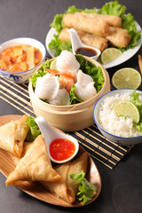 asian food selection with spring roll,noodles soup, dumpling and sauce