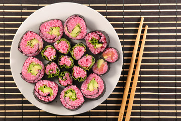 vegetarian sushi in plate with chopsticks