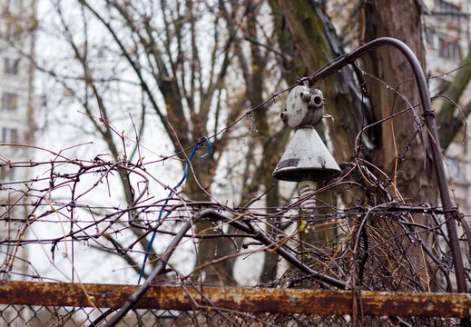 Old lamp and barbed wire.. Old, rusty lantern on a fence with barbed wire.