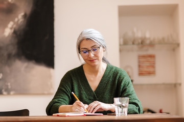 Concentrated mature beautiful grey-haired woman