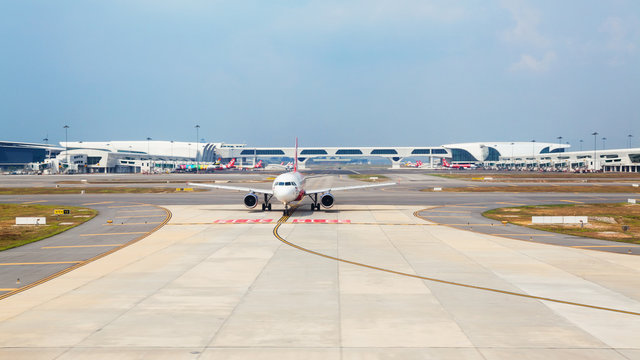 Kuala Lumpur, Malaysia - September 5, 2015: Air Asia Low Cost Airline Aircraft On The Background Of Transit Passenger Terminal Building Waiting For Take Off In Malaysian International Airport KLIA 2