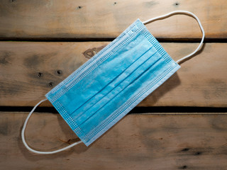 Medical mask on a wooden background. Medical equipment.