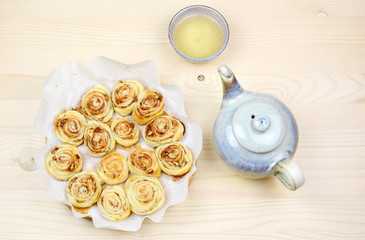 Homemade puff pastry cinnamon rolls served with green tea as breakfast, Czech republic, Europe.