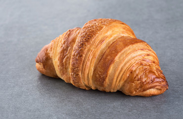 Croissant on a gray background.