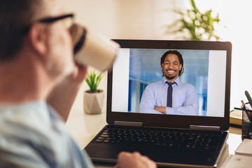 Businessman chatting with his colleague. Working at home.