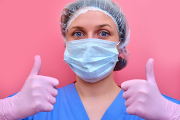 The doctor hands, in a pink medical glove, gives a thumbs - up gesture of approval. A nurse in a blue uniform makes a gesture that everything is fine