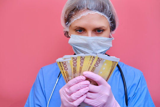 A woman medical doctor holds cash euros in her hands. A nurse girl with money in a protective mask on a red background.