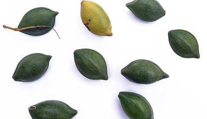 Indian, beach or tropical almonds of green and yellow colors isolated against a white background. Fruits are in a scattered pattern.