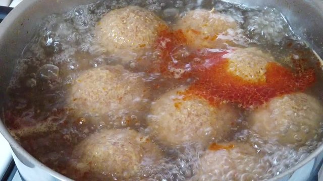Slow motion video of Traditional Turkish Food; Stuffed Meatballs,  Turkish known as "icli kofte".  Boiled in a pot