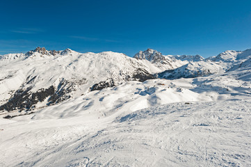 Fototapeta na wymiar View down a piste in alpine ski resort