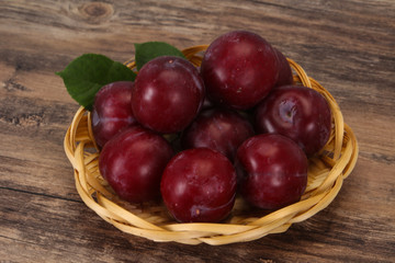 Plum heap in the wooden basket