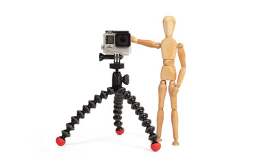 Wooden dummy standing trying to make a video or photo