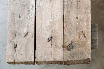 Old boards held together with rusty nails. Texture of vintage weathered wood surface. Top view.