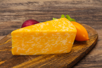 Marble cheese  triangle over wooden