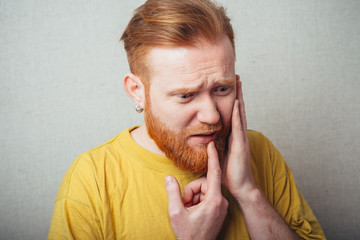 bearded man in a toothache