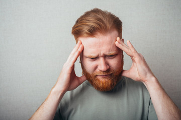 bearded man in a headache