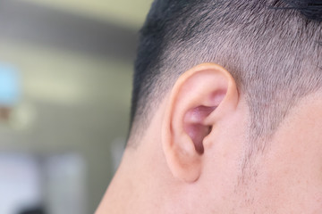 Obraz premium Close up of the right ear of a man and the place on the left side for placing letters.