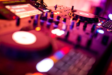 Obraz na płótnie Canvas DJ Spinning, Mixing, and Scratching in a Night Club. DJ playing music at mixer . Closeup. Party.