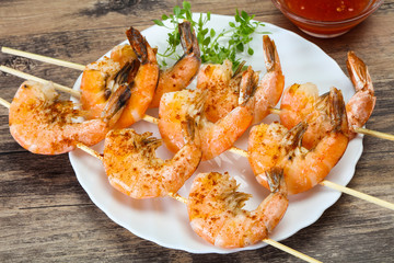 Grilled prawn skewer with sauce