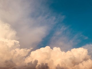 white cumulus clouds against deep blue sky