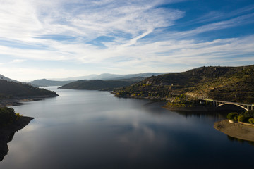 Magnificent view of the Burguillo reservoir at sunset. Popular tourist attraction. Cinematic scene in the middle of nature, located in the Ávila area. The world of beauty.