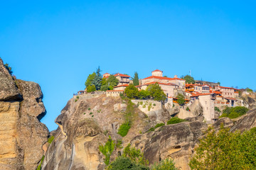 Fototapeta na wymiar Rocks and Stone Monastery Against the Blue Sky