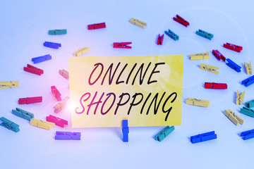 Handwriting text Online Shopping. Conceptual photo consumers directly buy goods from a seller over the Internet Colored clothespin papers empty reminder white floor background office