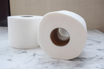 White toilet paper in rolls, lying sideways