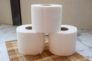 Toilet paper, 3 rolls are on the table, rolls of toilet paper
