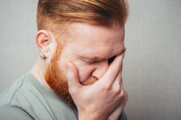 Fototapeta premium portrait of a Young red bearded Man feel bad, sad
