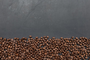 coffee beans on black wooden table background. top view