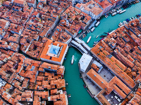 Overhead drone view of Rialto bridge at sunset, Venice, Italy