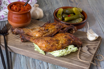 Fried chicken legs on a cutting board close-up.