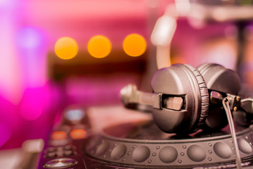 Fototapeta na wymiar DJ Spinning, Mixing, and Scratching in a Night Club. DJ playing music at mixer . Closeup. Party.