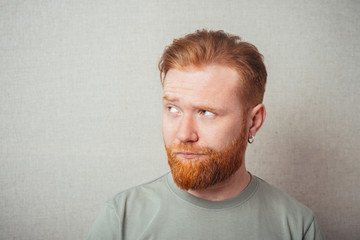 Young hipster red bearded Man Looking Impared