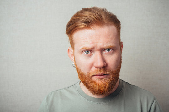 Young hipster red bearded Man Looking Impared
