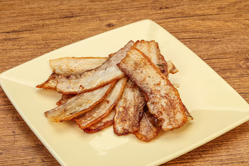 Roasted juicy bacon in the plate