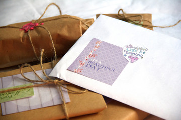 White envelope with brown paper gifts.