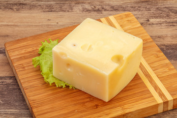 Emmental cheese over wooden board