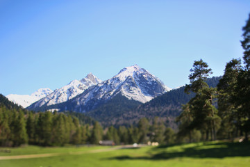 tilt shift stunning mountain landscape. Travel tourism snow peaks view. Hiking reserve Arkhyz...