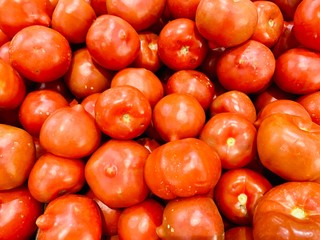Background of bright red tomatoes in the market