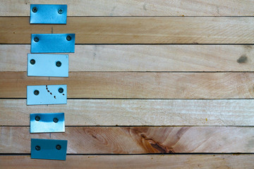 Stacked wooden slats, with bolt inserted over metal plate , ready for next usability in producing