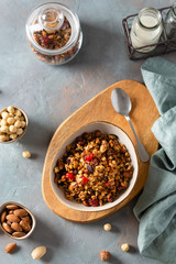 Dry breakfast cereals. Crunchy honey granola bowl with flax seeds, cranberries and nuts. Healthy, vegeterian fiber food. Breakfast time. Dieting concept. Top view