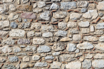 The background old gray stony wall