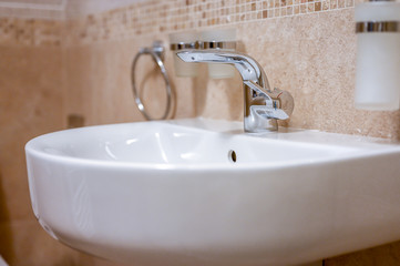 Fototapeta na wymiar Water flow from faucet. Sink n bathroom with water tap.